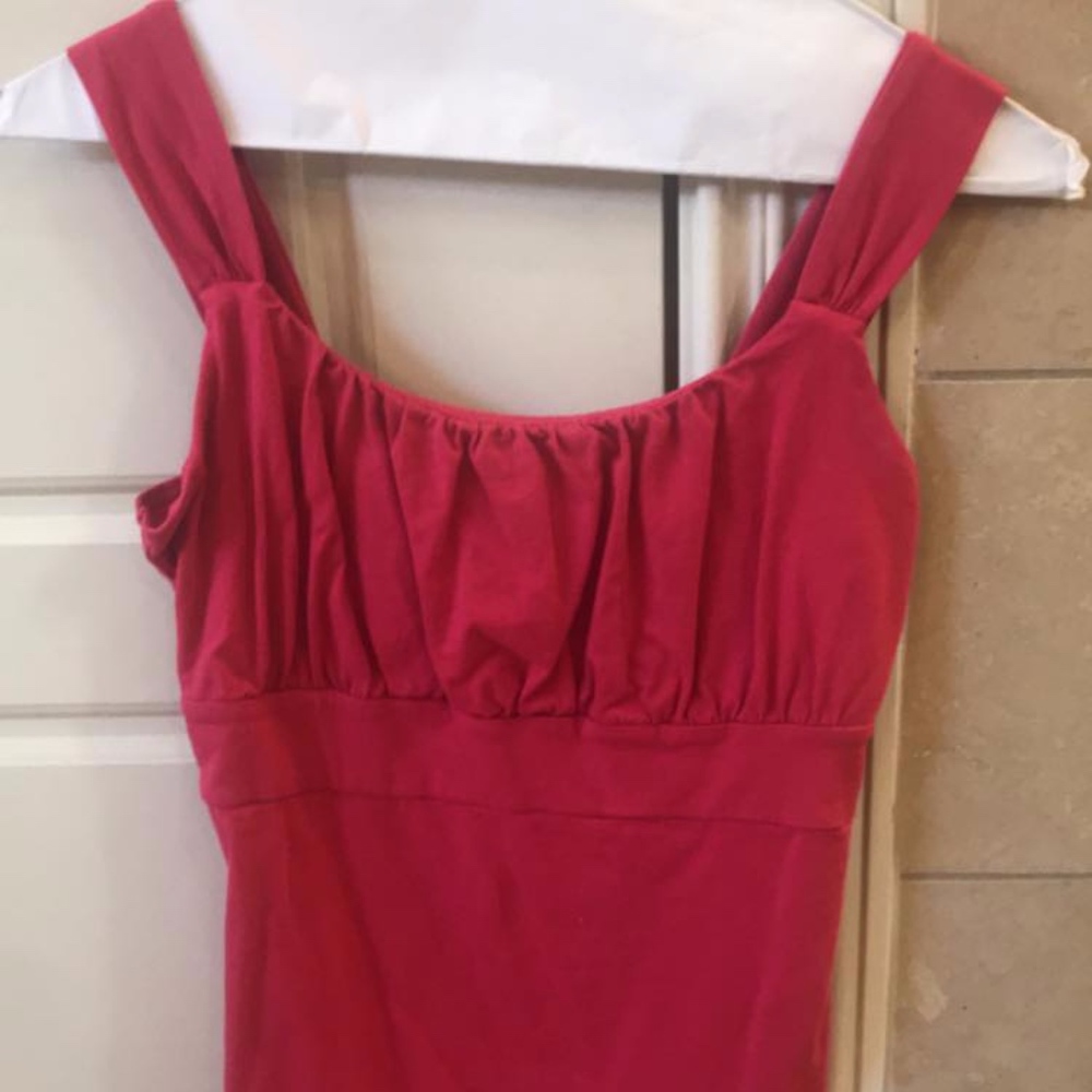 Hot pink empire waist sleeveless top with ruching.